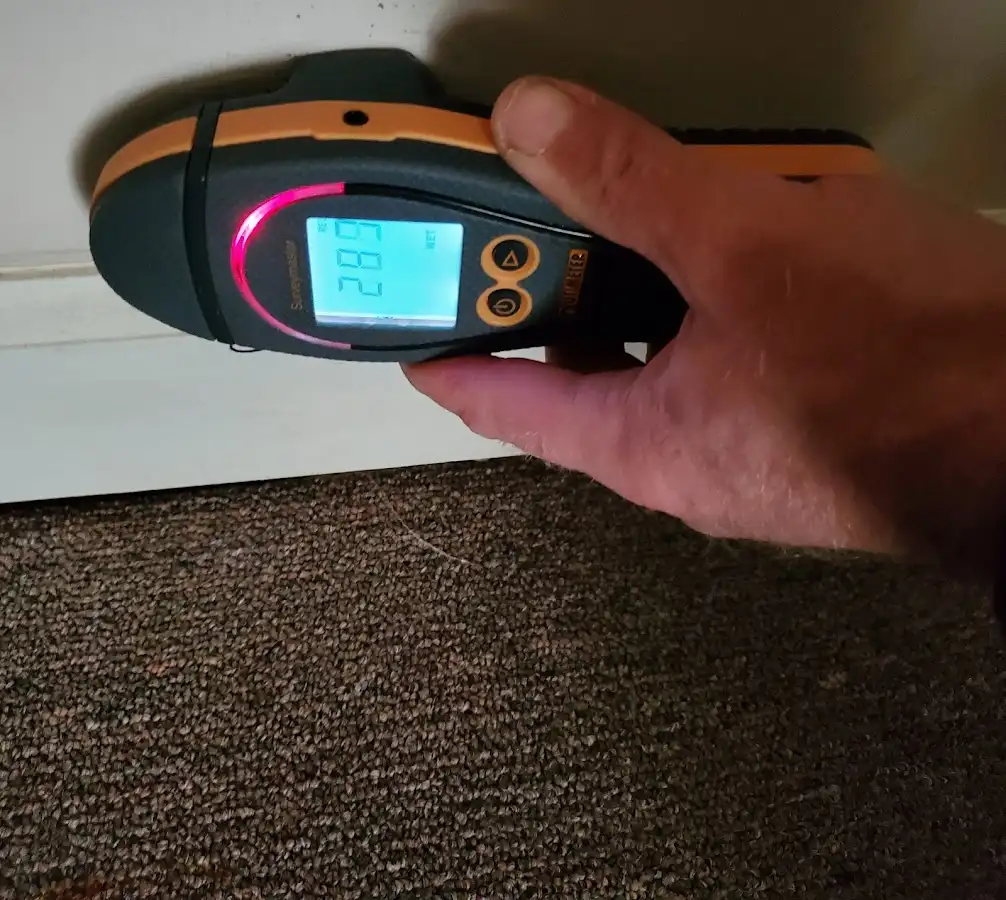 Moisture detection at baseboard during Storm Damage Restoration in Wendell