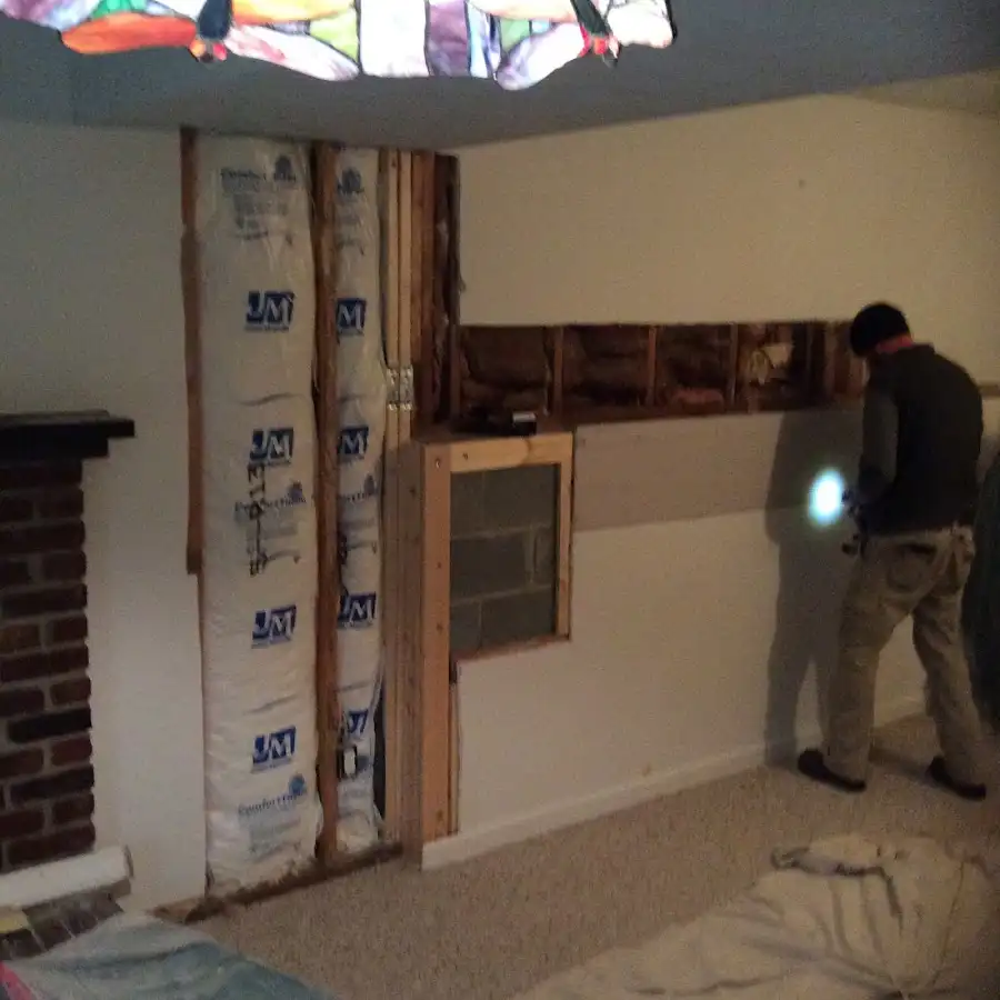 Restoration technician inspecting water damage in Wendell